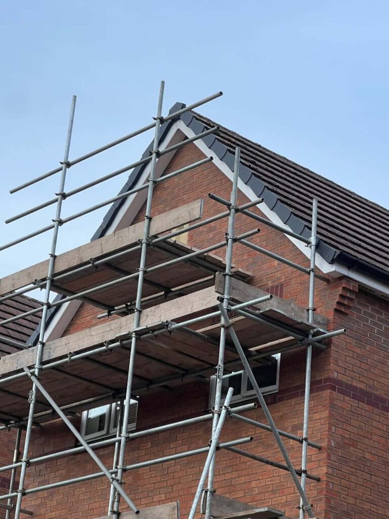 This is a photo of a roof which has just been repaired. There is a scaffold located at the gable end for access onto the roof. Works carried out by Bexleyheath Roofing Repairs